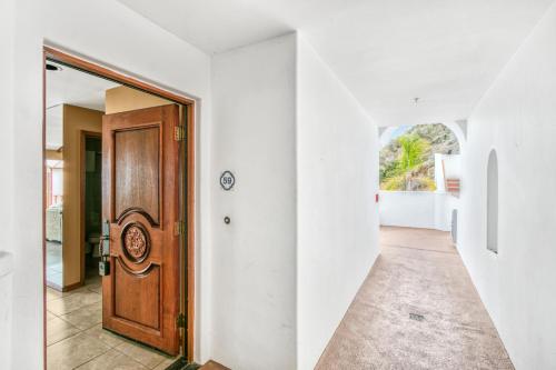 an empty hallway with a wooden door in a house at H159 - Hamilton Cove Villa 1-59 in Avalon
