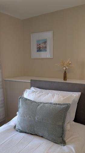 a bedroom with a bed with a gray and white pillow at Duke of Cornwall in St Austell