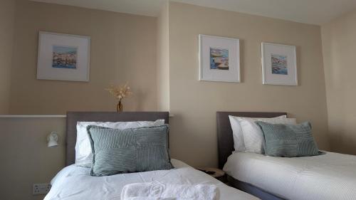 two beds sitting next to each other in a bedroom at Duke of Cornwall in St Austell