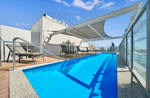 a swimming pool on the roof of a building at In the city Perth 1B1B Pool and nice view in Perth