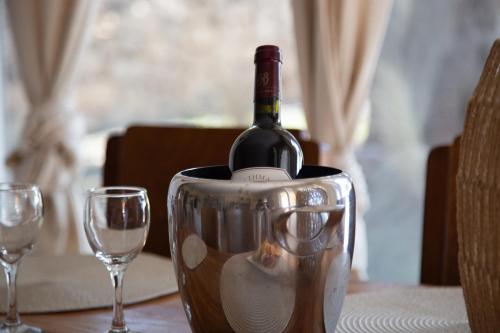 a bottle of wine in a bucket on a table at Poseidon Apartments and Villas by the Sea in Sounio