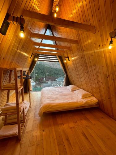 a bedroom with a bed in a wooden room at Balandda Chimgan in Chimgan