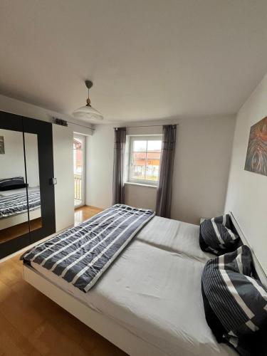 a bedroom with a large bed and a window at Wohnung mit Bergblick in Waging am See