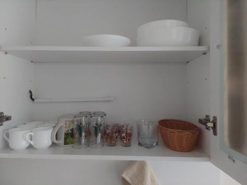 a shelf with jars and other kitchen items on it at Apartment Relax Chamkoria Borovets in Borovets