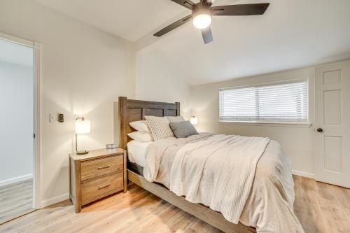a bedroom with a bed and a ceiling fan at 1 Mi to Table Rock Lake Home with Furnished Patio! in Blue Eye