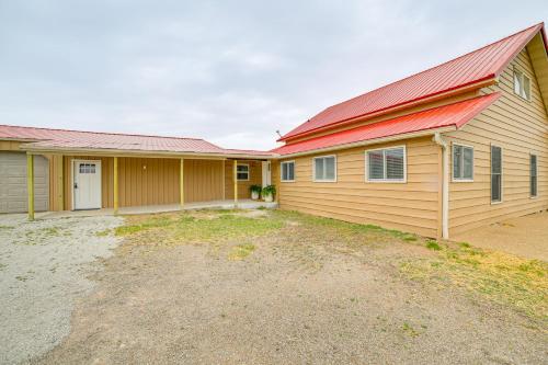 a house with a red roof and a driveway at 1 Mi to Table Rock Lake Home with Furnished Patio! in Blue Eye