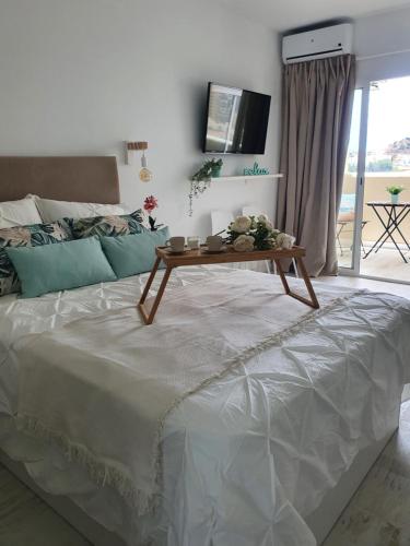 a bedroom with a bed with a table on it at Benalbeach Playa in Benalmádena