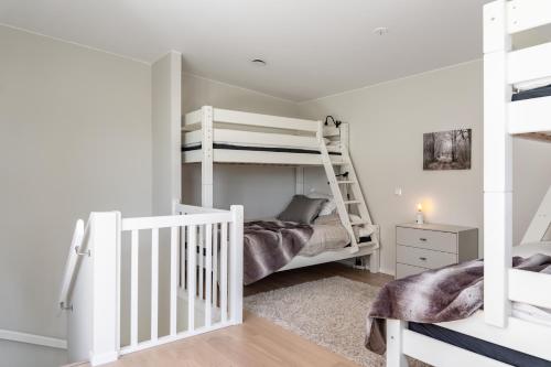 a bedroom with two bunk beds and a staircase at Cozy, designed, Beach House apartment in Beddinge Strand
