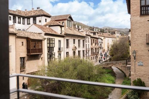 a view of a city with a bridge and buildings at Las Amiras Homes Collection in Granada