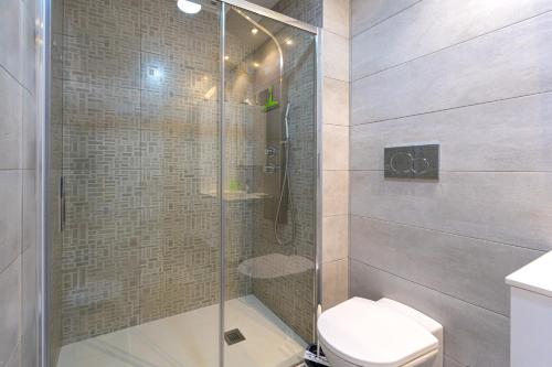 a bathroom with a glass shower with a toilet at Cathy in San Juan de los Terreros