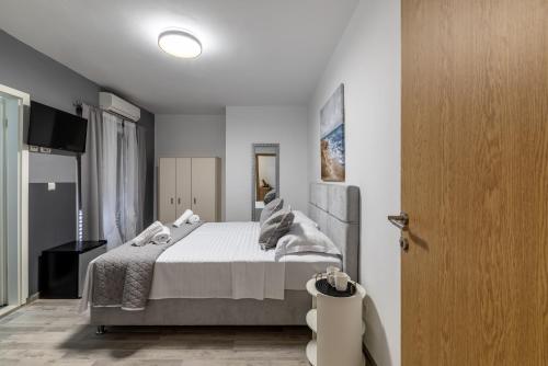 a bedroom with a large bed with white sheets and pillows at Villa Valamare in Podstrana