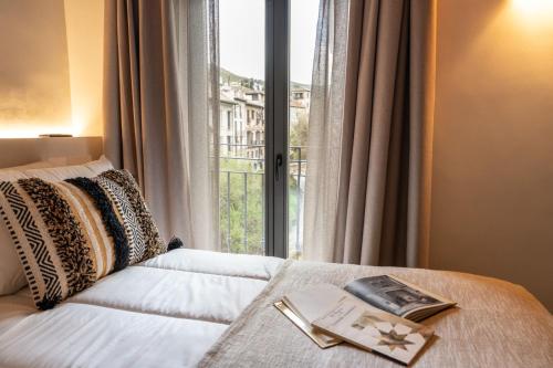 a bedroom with a bed and a large window at Las Amiras Homes Collection in Granada