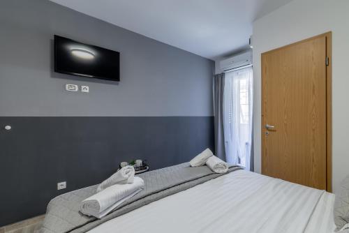 a bedroom with a large bed with towels on it at Villa Valamare in Podstrana