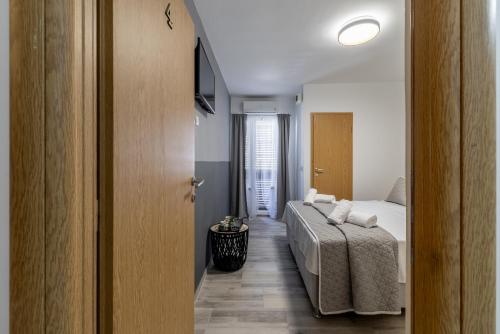 a bedroom with a bed and a door to a hallway at Villa Valamare in Podstrana