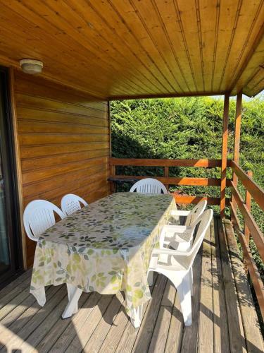 a table and chairs on a wooden deck at Chalet en bois à Désaignes in Désaignes