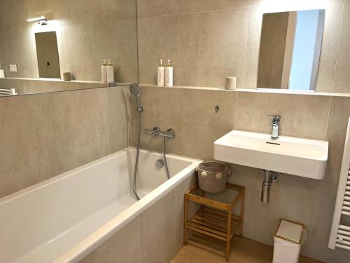 a bathroom with a sink and a bath tub and a sink at Luxury aparment in Eurovea Tower in Bratislava