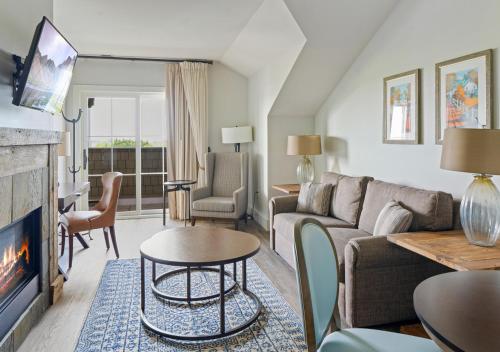 a living room with a couch and a fireplace at The Inn at Chesapeake Bay Beach Club in Stevensville