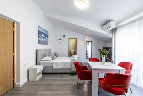 a bedroom with a bed and a table and chairs at Villa Valamare in Podstrana
