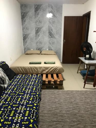 a bedroom with a bed and a table in it at Espaço Baobá Suítes Confortáveis in Camboriú