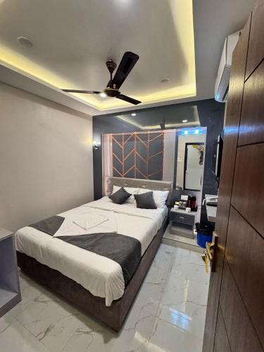 a bedroom with a large bed with a ceiling fan at Hotel Royal Mithila Private Limited in Janakpur