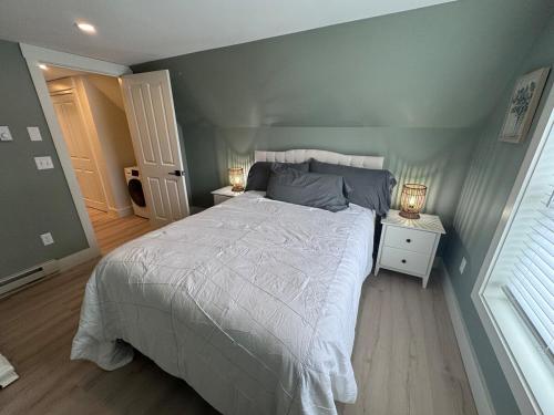 a bedroom with a large bed and two night stands at Seacoast Apartment in Windham