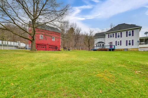 a green field with two houses and a red barn at 6 Acres with Pool Spacious Naples Vacation Rental! in Naples