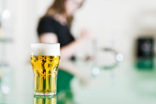 a glass of beer sitting on top of a table at Hotel Klettur in Reykjavík