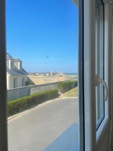 a view of a road from a window at Grand Studio Balnéaire in Luc-sur-Mer