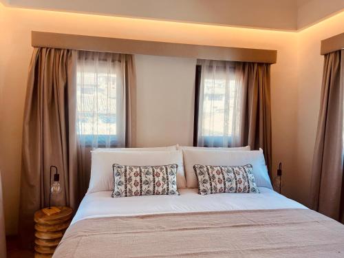 a bedroom with a large white bed with two pillows at Las Amiras Homes Collection in Granada