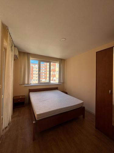 a bedroom with a large bed with a window at Privilege First Line Sea in Elenite