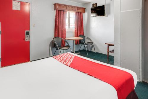 a hotel room with a bed and a table and chairs at OYO Hotel Liberal, Kansas in Liberal
