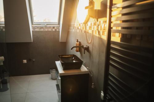 a small bathroom with a sink and a window at Szklany Przystanek in Kościerzyna