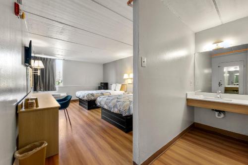 a hotel room with two beds and a sink at Motel 6-Decatur, GA in Decatur