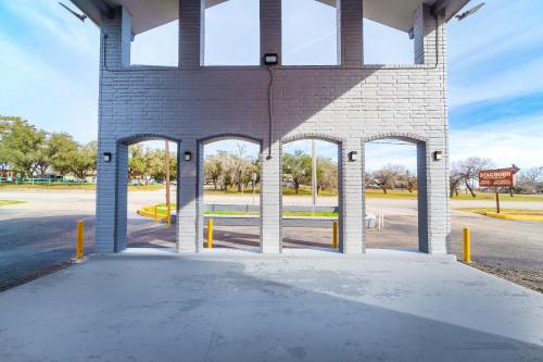 an empty parking lot in a brick building at Regency Inn By OYO Three Rivers in Three Rivers