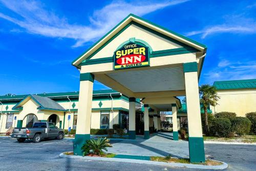 a super am store with a sign on it at Super Inn & Suites by OYO Milledgeville in Milledgeville