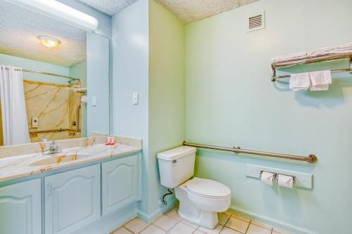 a bathroom with a toilet and a sink at OYO Townhouse Tulsa Woodland Hills in Tulsa