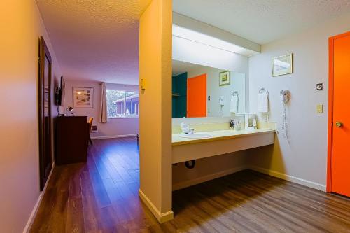 a bathroom with a sink and a mirror at Coast River Inn by OYO Seaside in Seaside