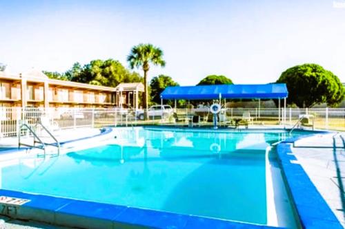 a large swimming pool with blue water at OYO Hotel Mustang Silver Spring FL in Silver Springs