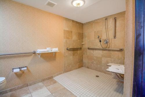 a bathroom with a shower and a toilet at Tulsa Square Hotel Central, I-44 By OYO in Tulsa