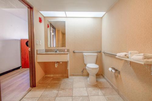 a bathroom with a toilet and a sink at Tulsa Square Hotel Central, I-44 By OYO in Tulsa