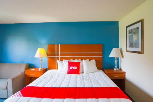 a bedroom with a bed with a red pillow on it at OYO Hotel Redwood Falls near Jackpot Casino in Redwood Falls