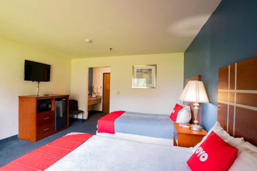 a hotel room with two beds and a television at OYO Hotel Redwood Falls near Jackpot Casino in Redwood Falls
