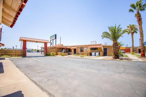 a empty parking lot in front of a motel at Sands Motel By OYO El Paso near Airport in El Paso