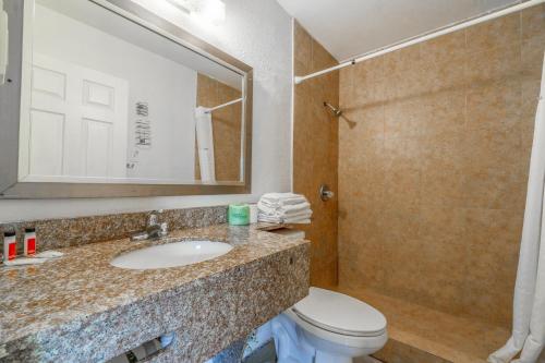 a bathroom with a sink and a toilet at Pelican Inn by Belvilla Aransas Pass, TX in Aransas Pass