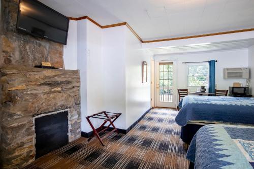 a hotel room with a fireplace and a bed at Lloyd's On The River Country Inn By Oyo in Bryson City