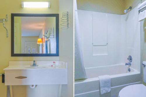 a bathroom with a sink and a tub and a toilet at Economy Inn By OYO Ashburn in Ashburn