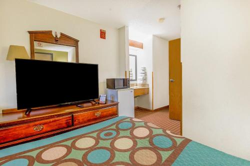 a living room with a large flat screen tv at Super Sleep Inn in Princeton