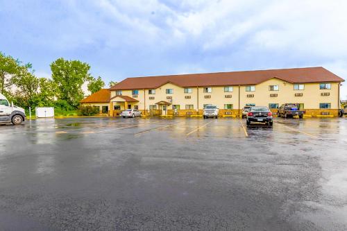 a large building with cars parked in a parking lot at Super Sleep Inn in Princeton