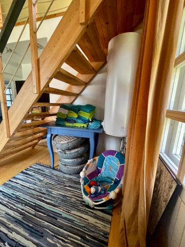 a room with a stairs with a table and a chair at Villa Blue Heaven Pärnu in Pärnu