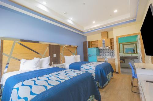a hotel room with two beds and a kitchen at La Vyoma Villas, Westpark Hwy 6 in Houston